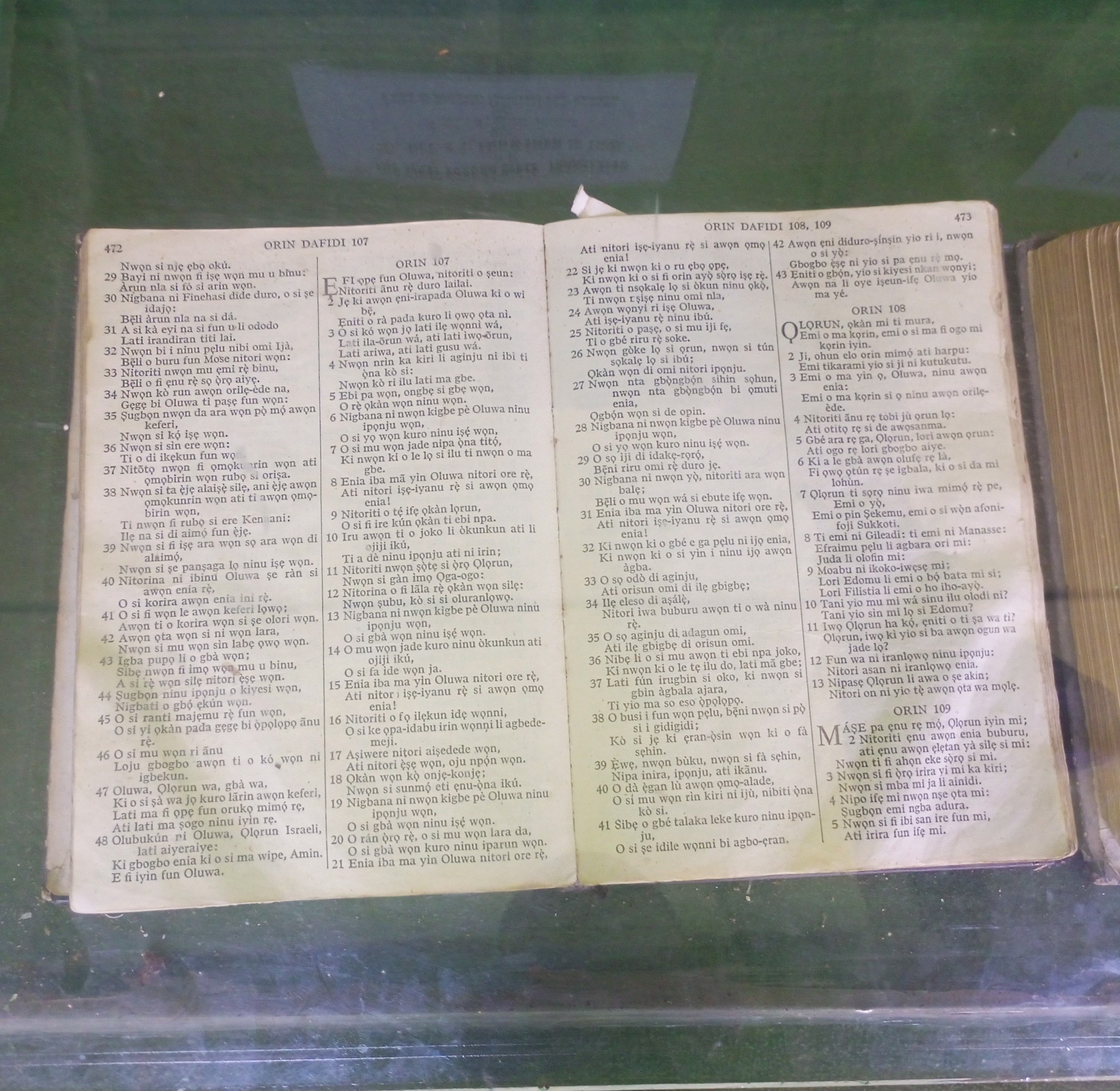 An old copy of the Yoruba Bible displayed under glass, open to the Psalms